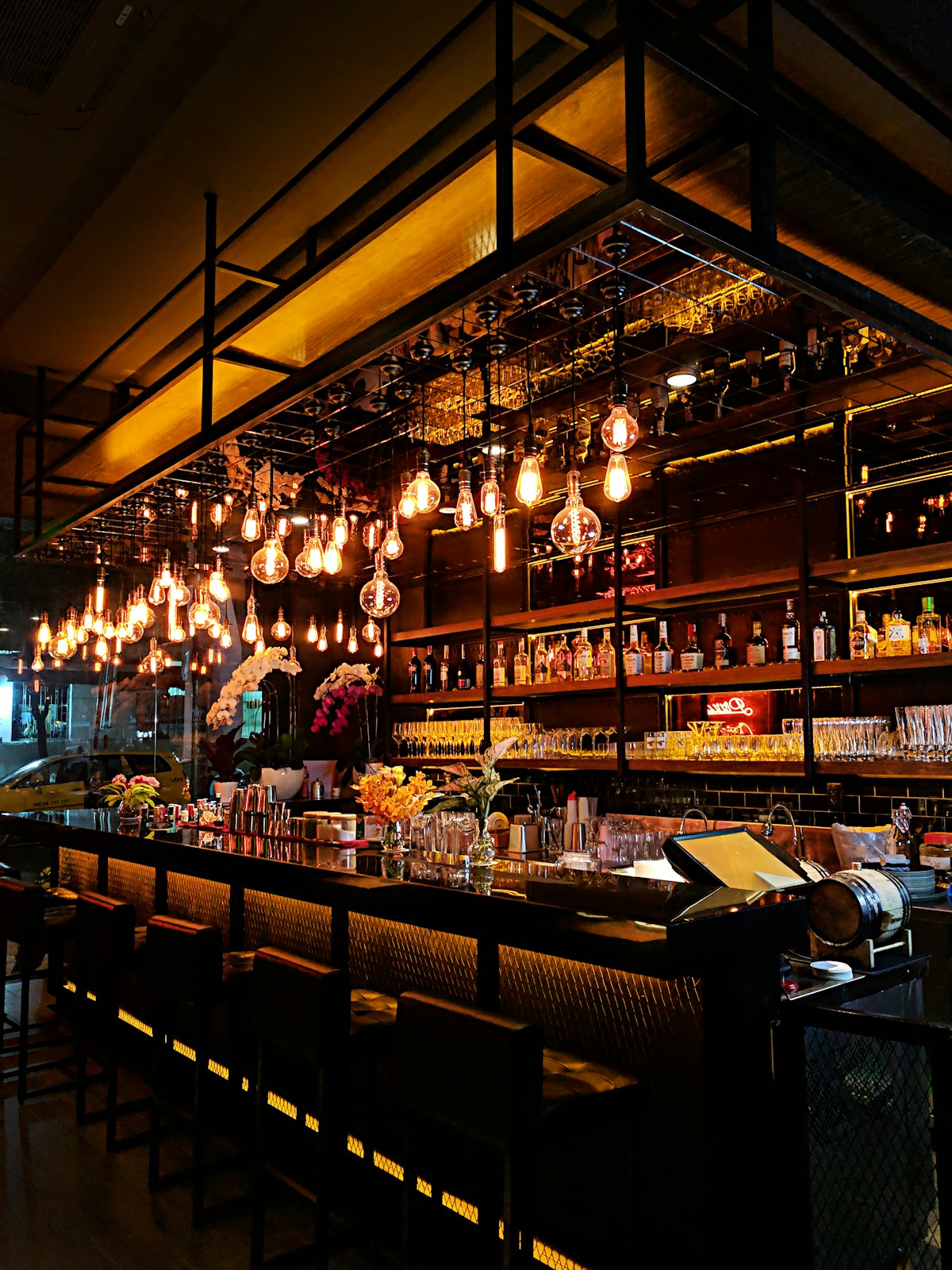 Edison bulb bar back with bottles and glasses